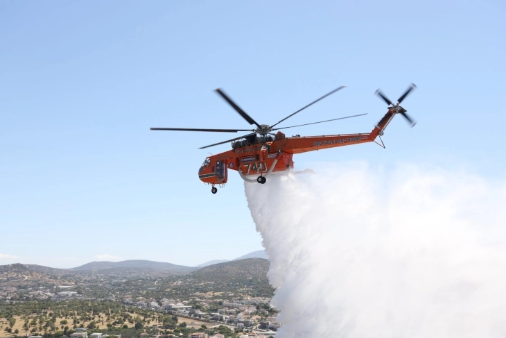 Firefighters battle blazes near Athens, some partly under control