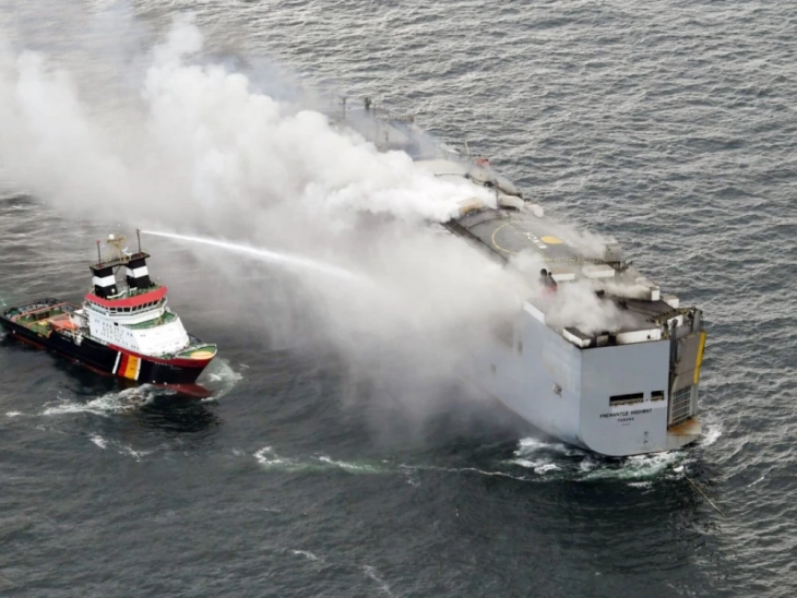 Burning car freighter towed toward Dutch island in risky operation