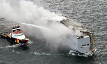 Burning car freighter towed toward Dutch island in risky operation