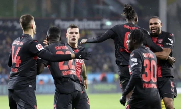 Stanisic keeps Leverkusen's unbeaten run alive in Dortmund draw